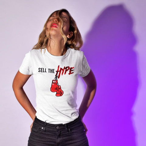 women modeling white graphic t shirt with the words Sell The HYPE Across The Chest With Red Boxing Gloves Icon - King Killers Apparel
